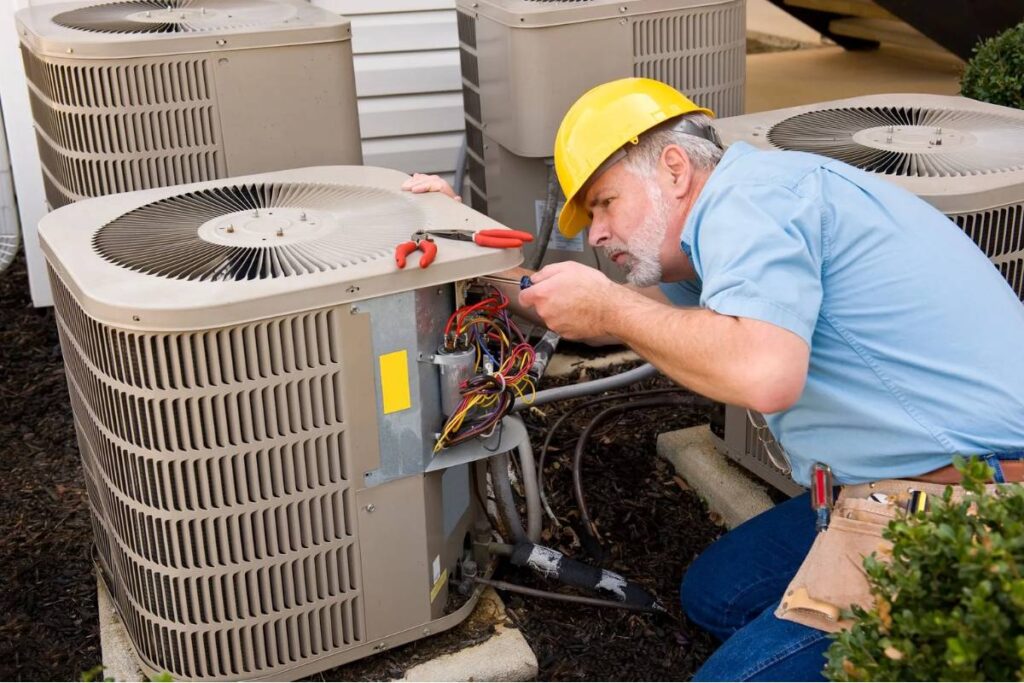 technician repairing an HVAC machine