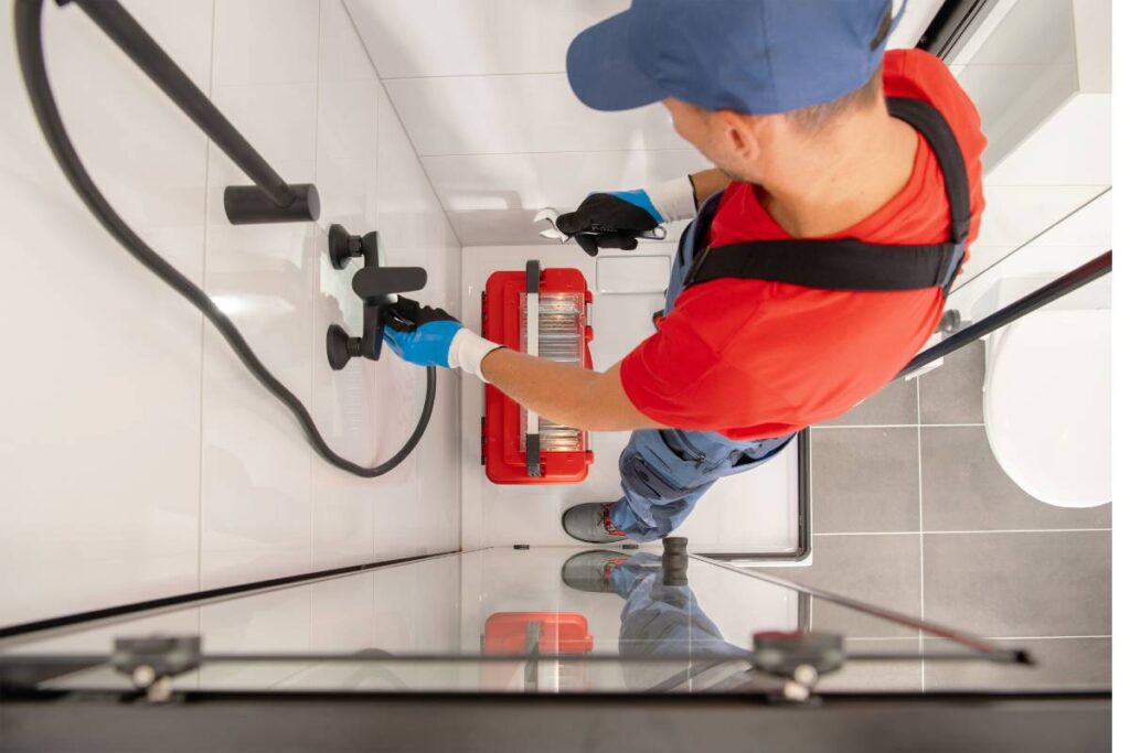 man working on shower room remodeling
